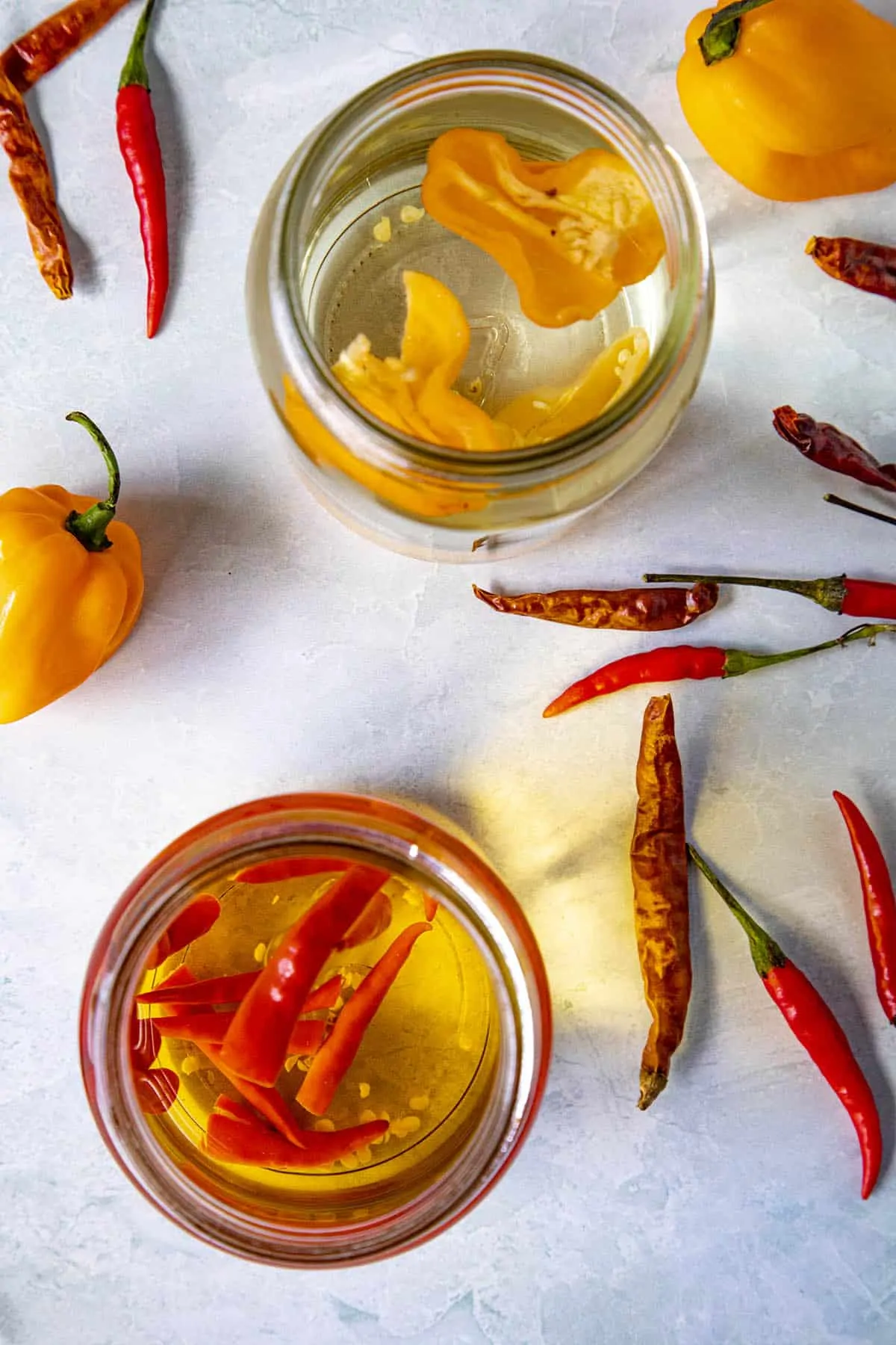 Spicy infused alcohol in jars with extra peppers