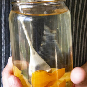 Infusing alcohol with spicy chili peppers in a ball jar