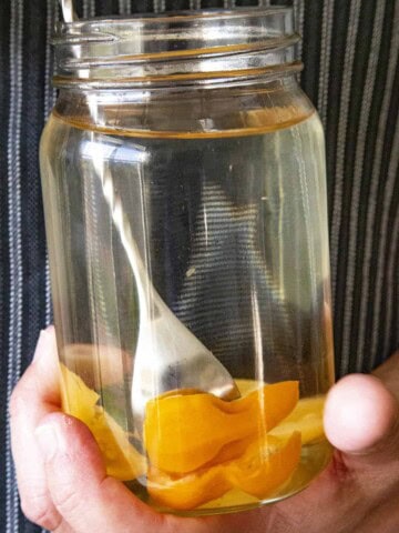 Infusing alcohol with spicy chili peppers in a ball jar