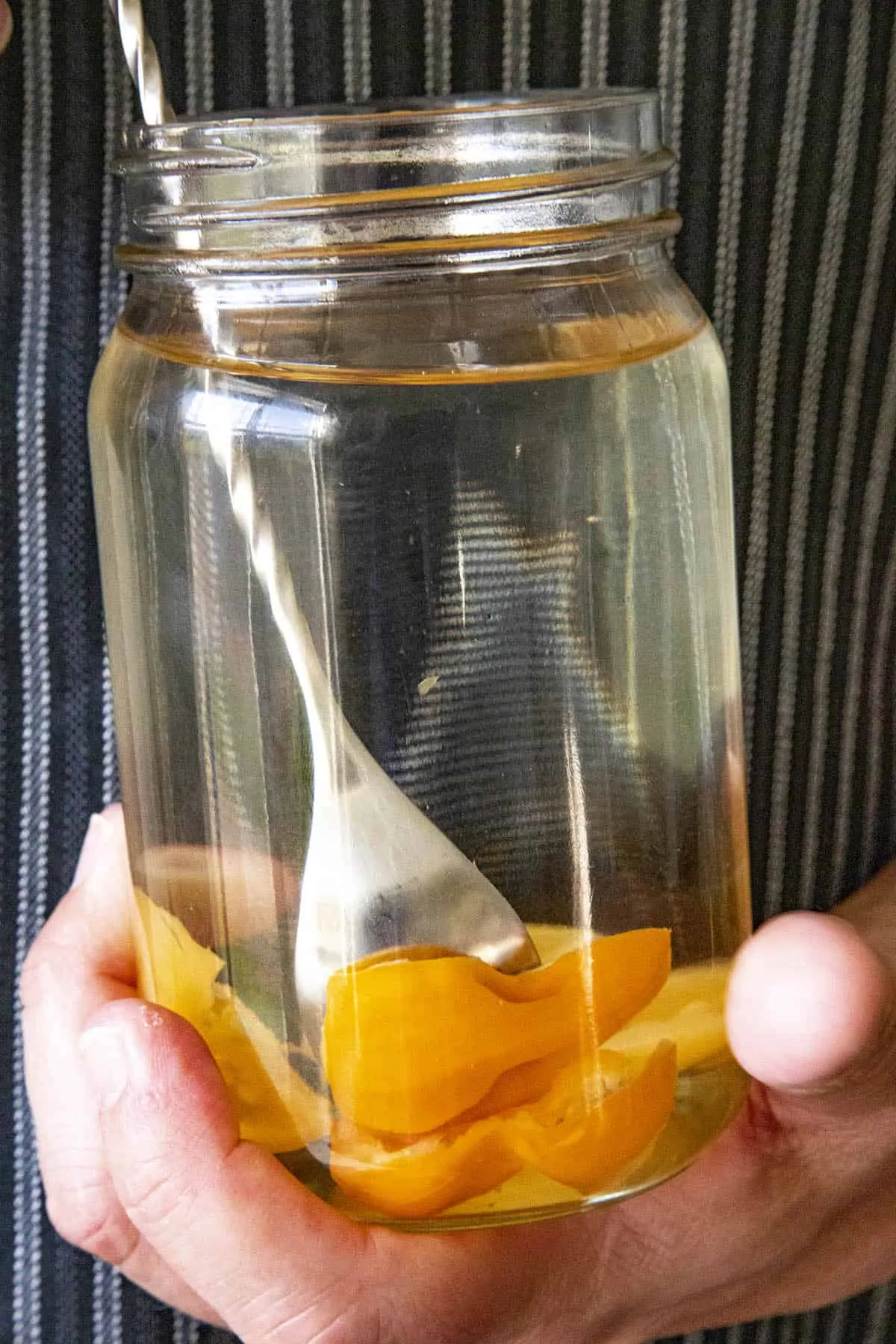 Infusing alcohol with spicy chili peppers in a ball jar
