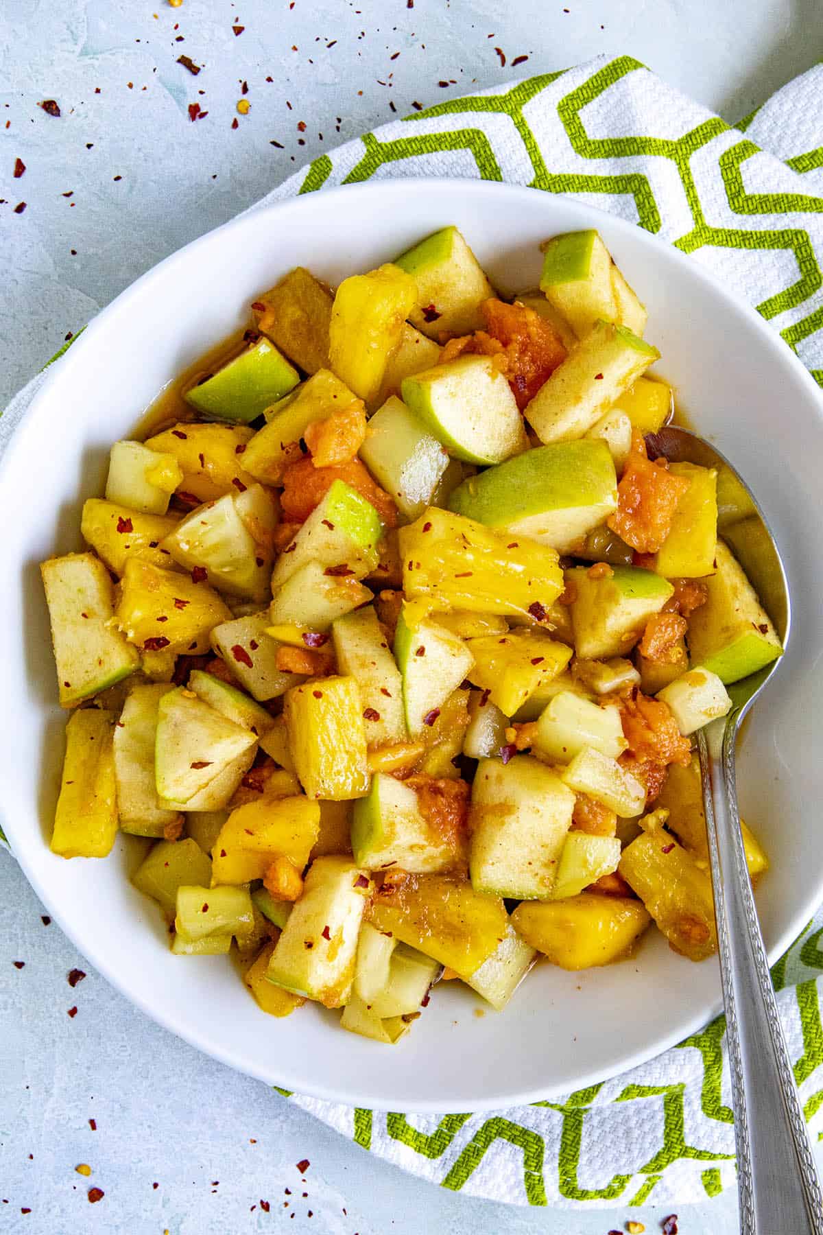 Rujak (Indonesian fruit salad) in a bowl with a spoonful of fruit