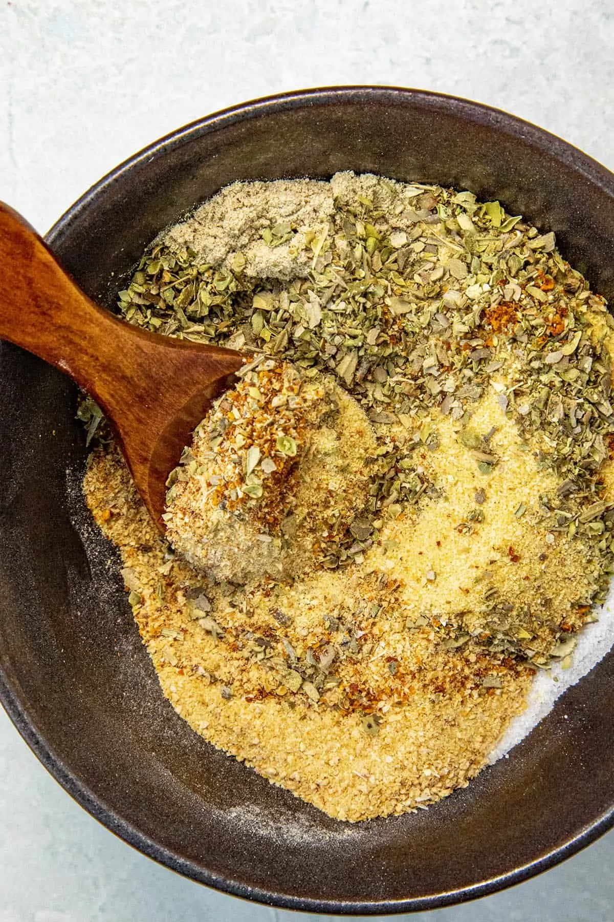 Adobo Seasoning ingredients being mixed in a bowl.