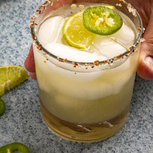 Mike taking the glass of Jalapeno Margarita