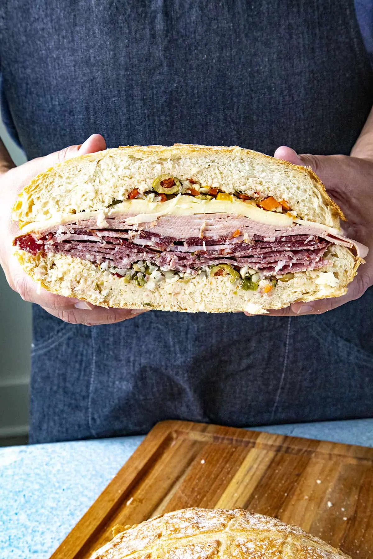 A thick and meaty Muffaletta sandwich sliced in half