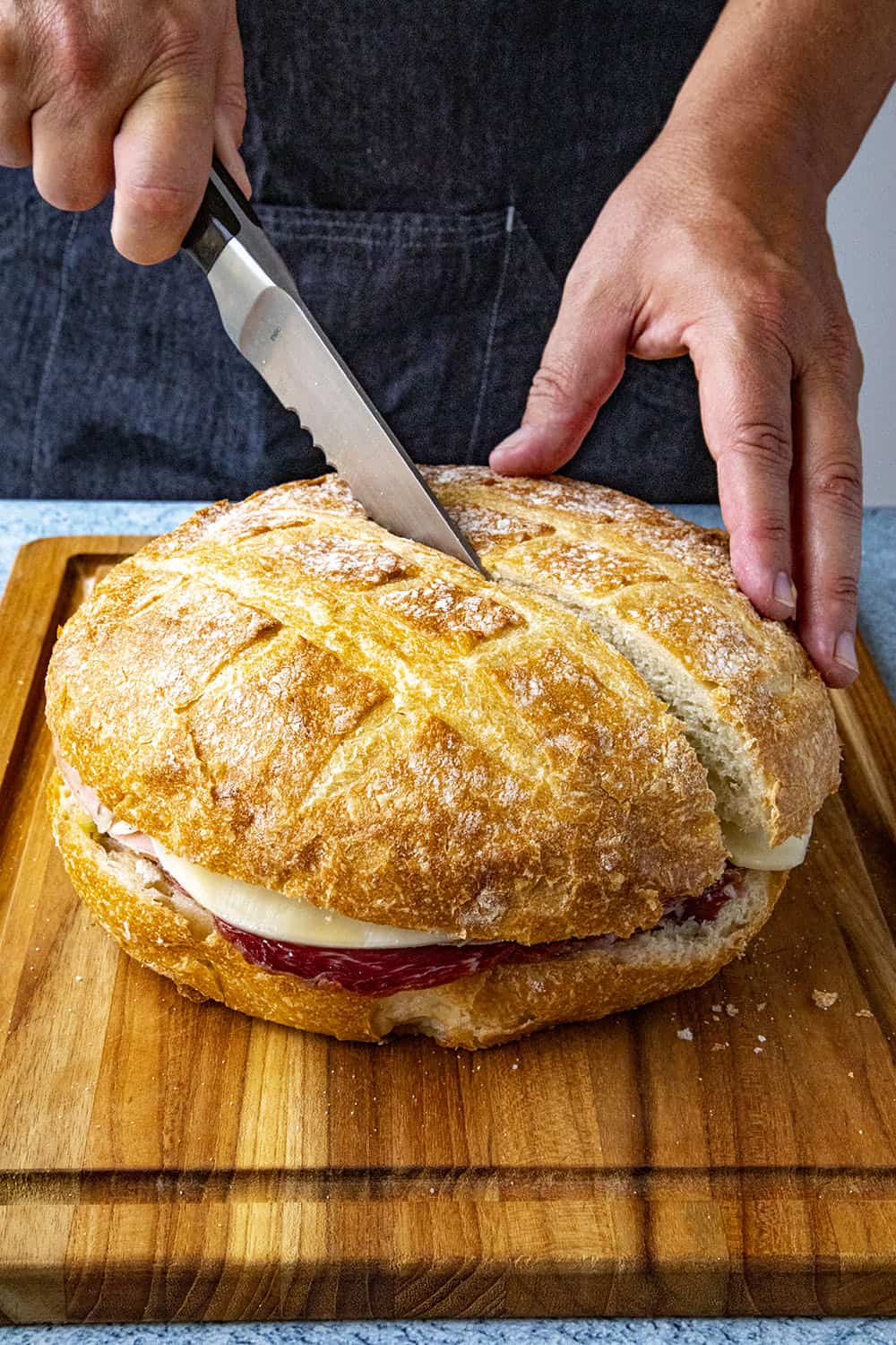 Mike slicing his muffaletta sandwich