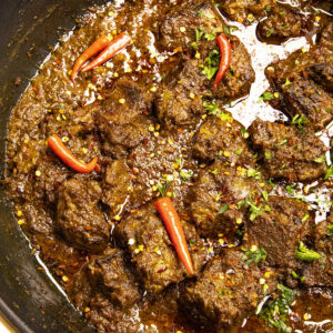 Beef Rendang simmering in a pot