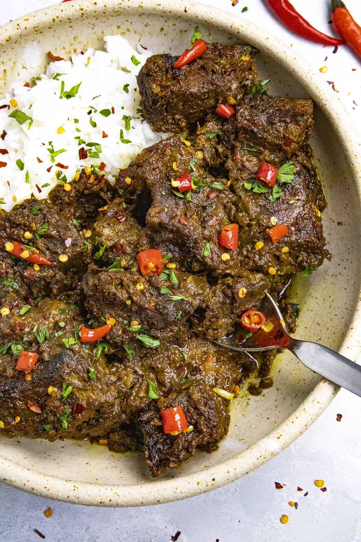 Beef Rendang in a bowl with a spoon