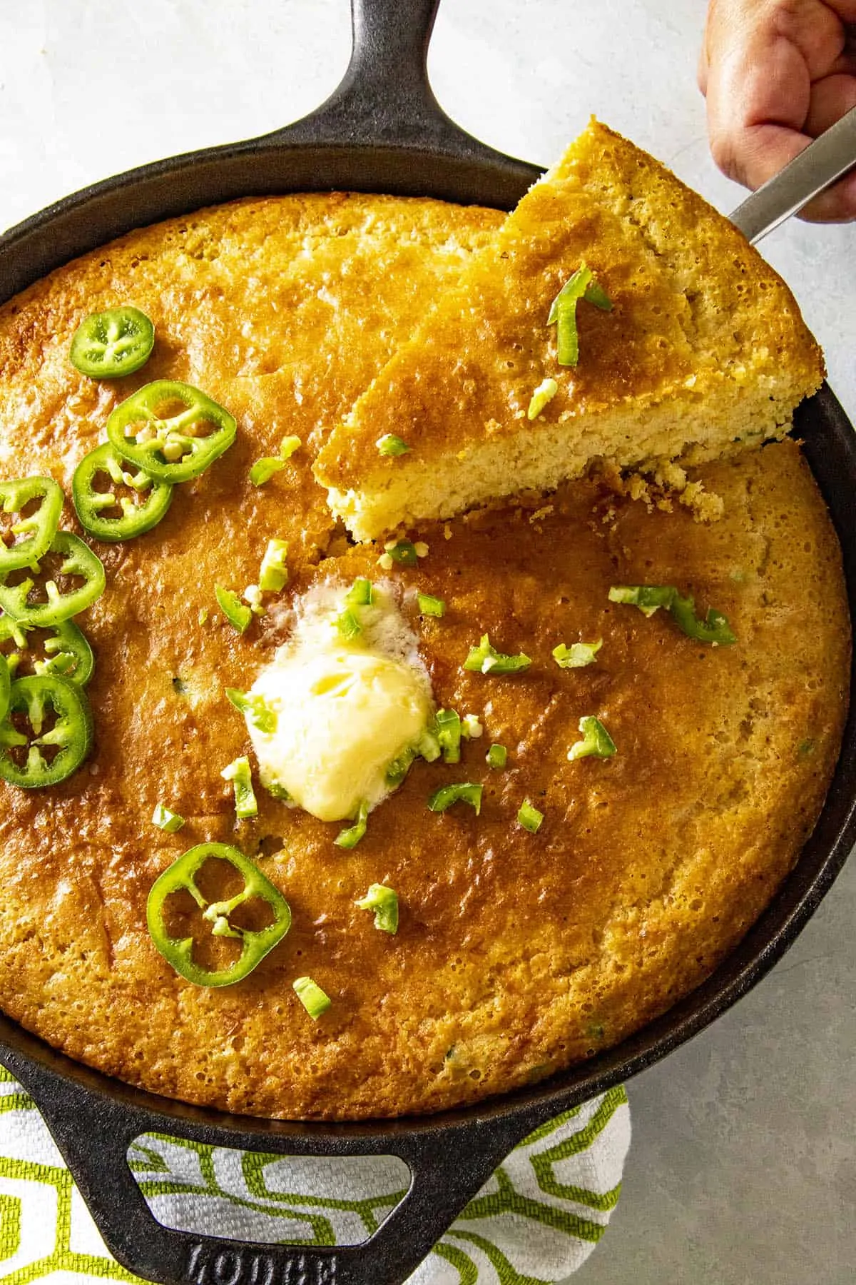 Mike slicing a piece of cornbread from the skillet