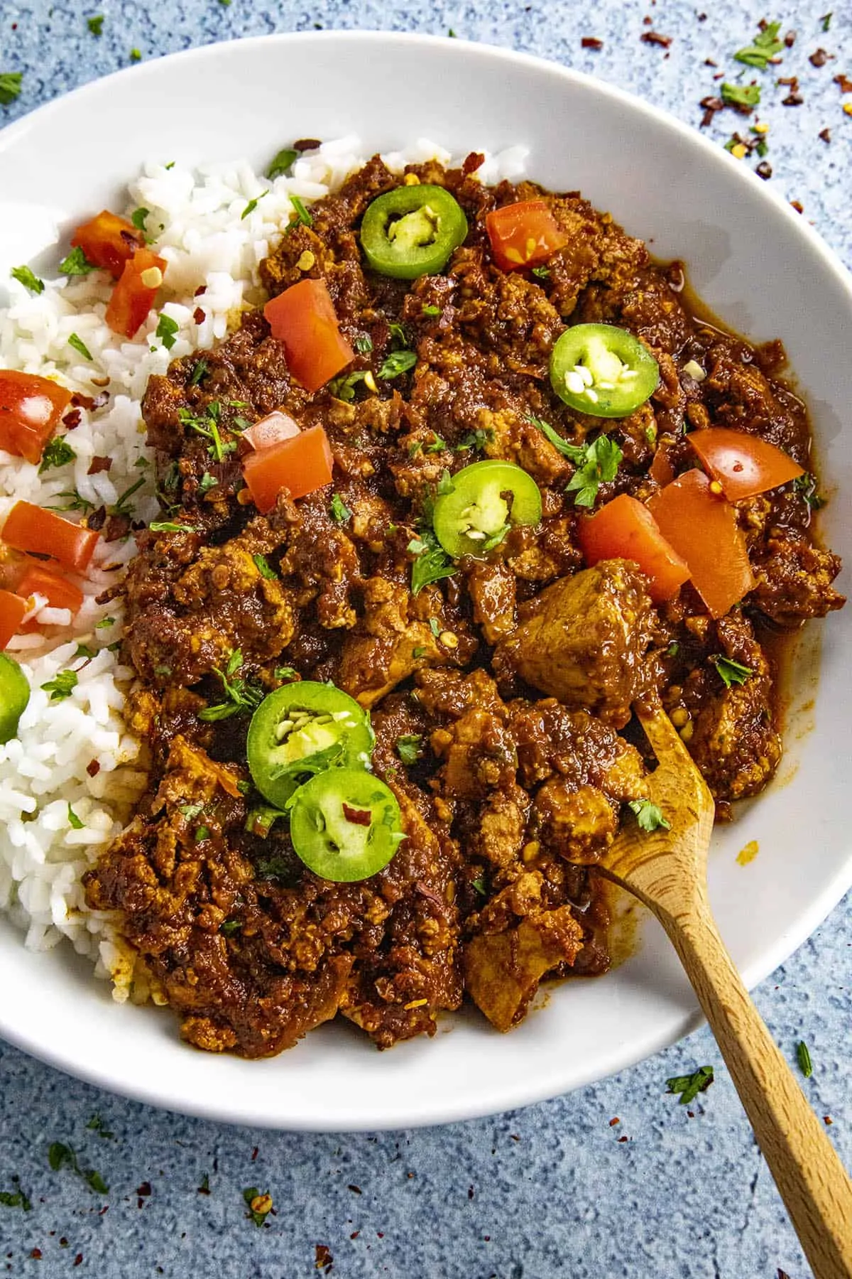 A sofritas bowl served with rice, serrano peppers and tomato