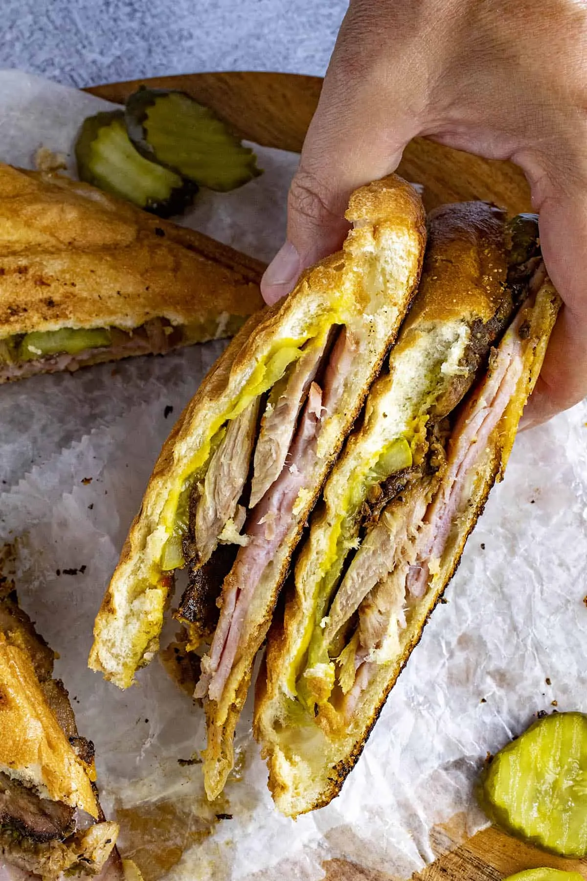 Mike grabbing a Cuban sandwich from the plate