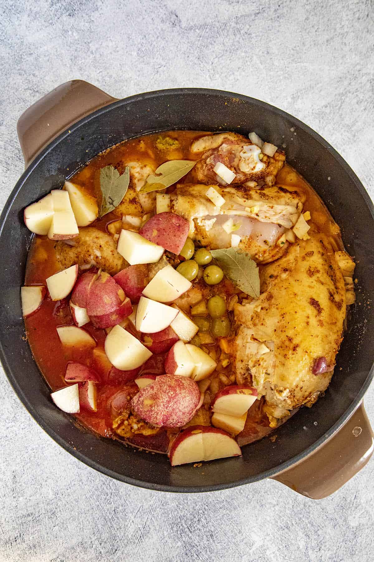 Simmering the pollo guisado in a pot