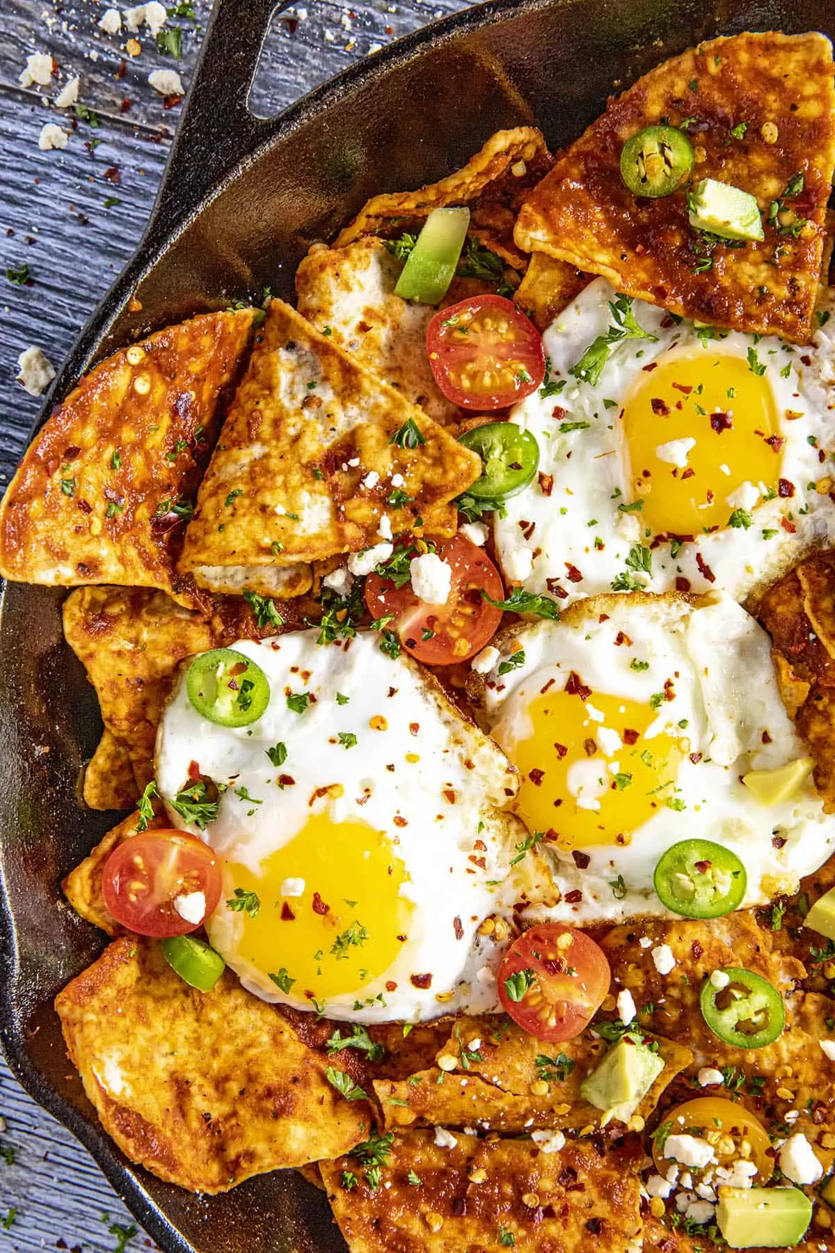 Big scoops of saucy chilaquiles rojos with fried eggs