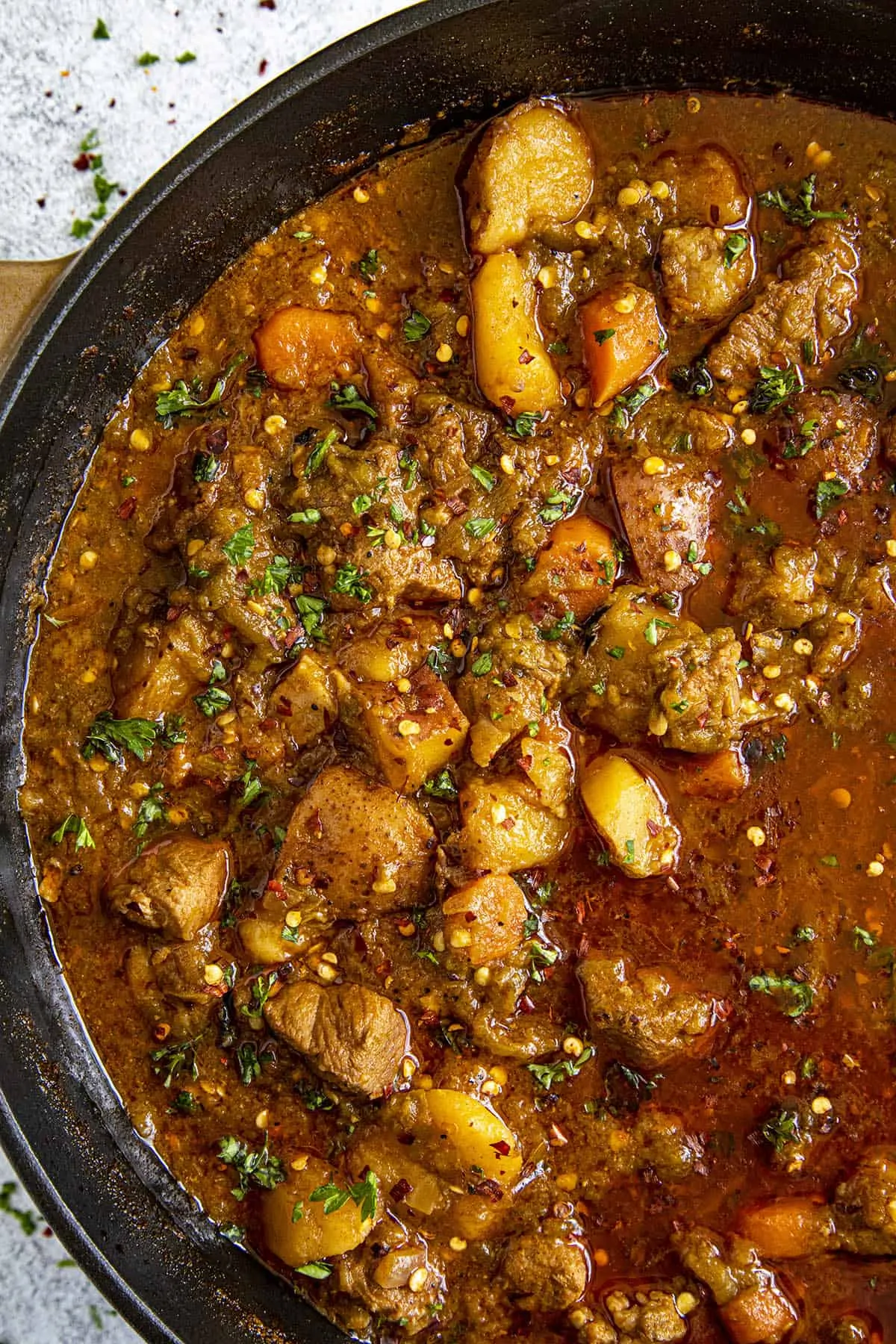 Chunky Green Chili Stew in a pot with lots of pork and potatoes.