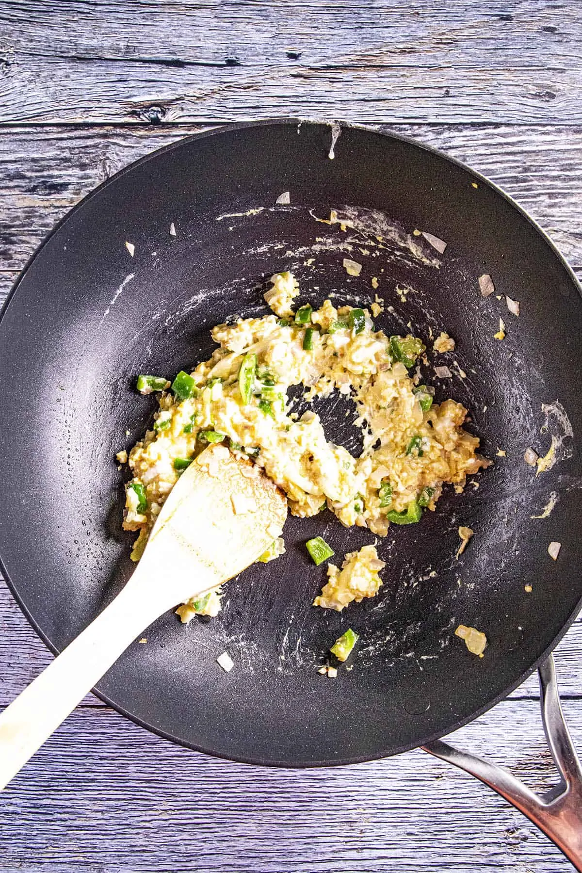 Scrambling eggs in a hot pan for making fried rice