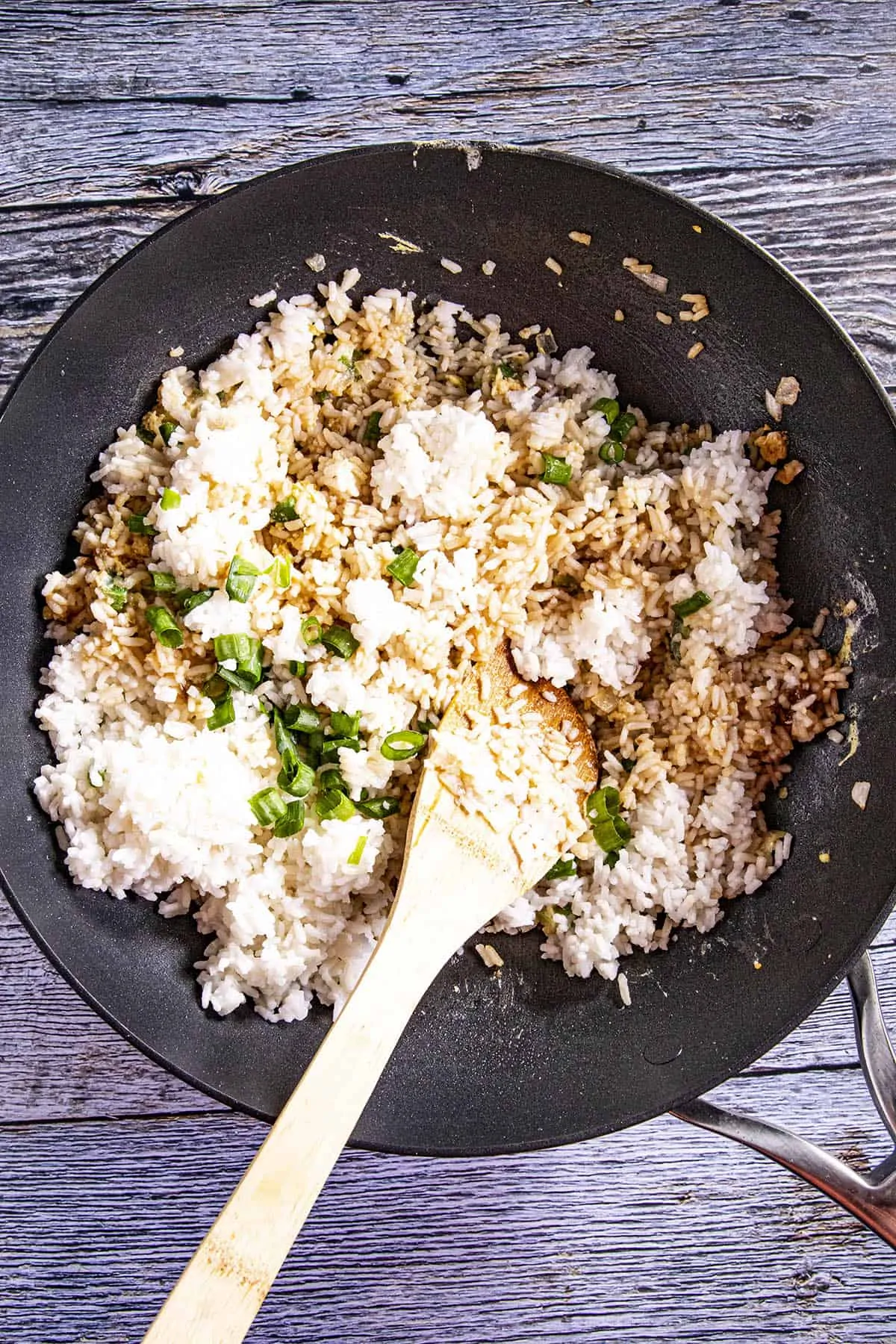 Stirring the remaining ingredients into the fried rice