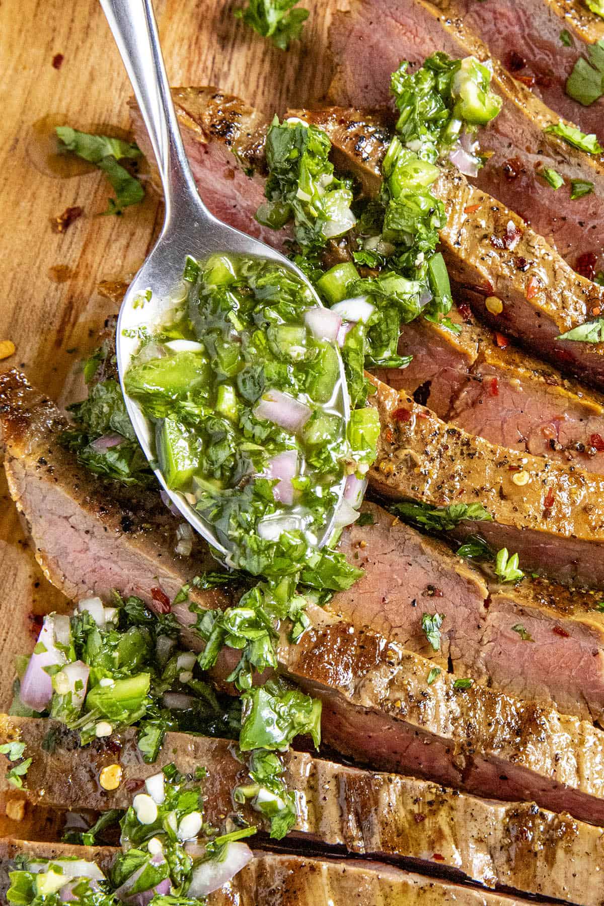 A heaping spoonful Chimichurri over flank Steak
