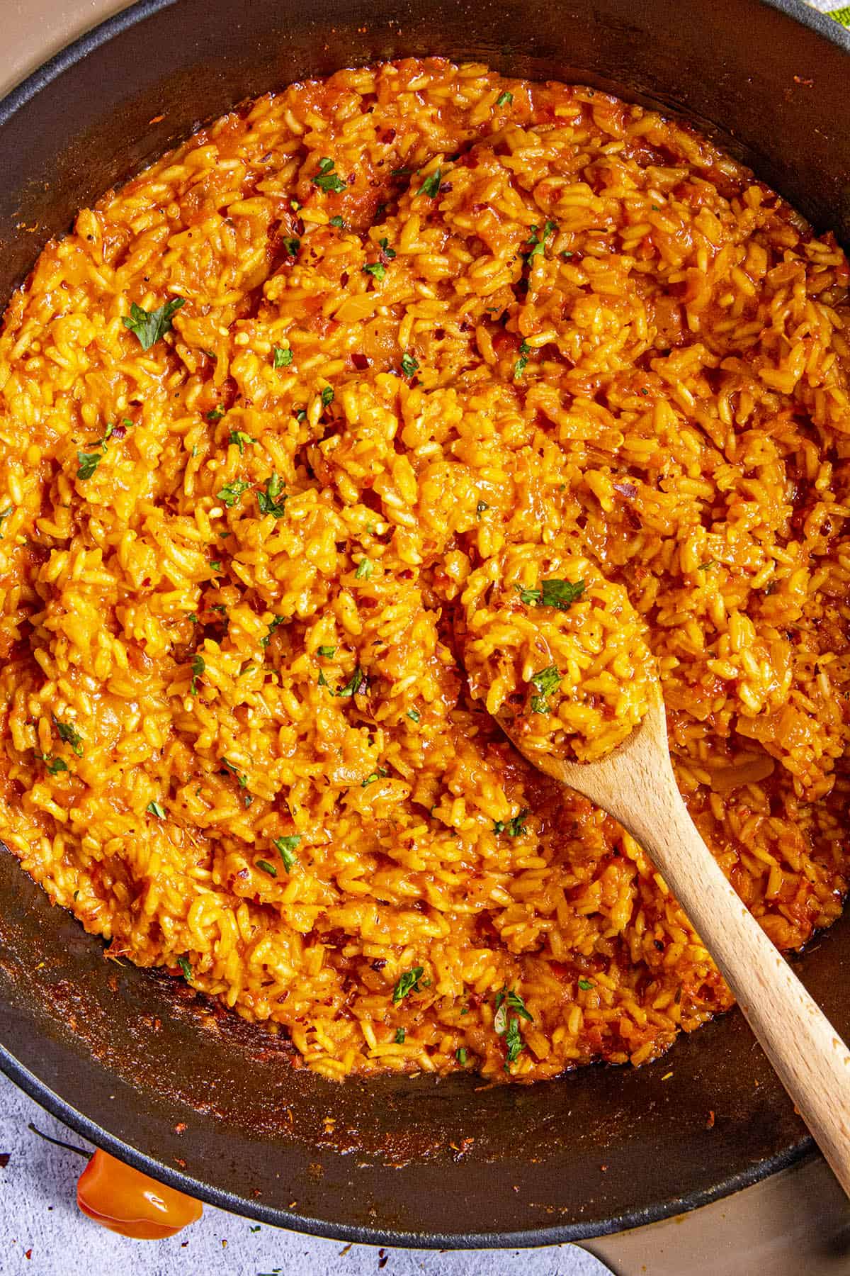 Jollof Rice in a pot with a spoon, ready to serve