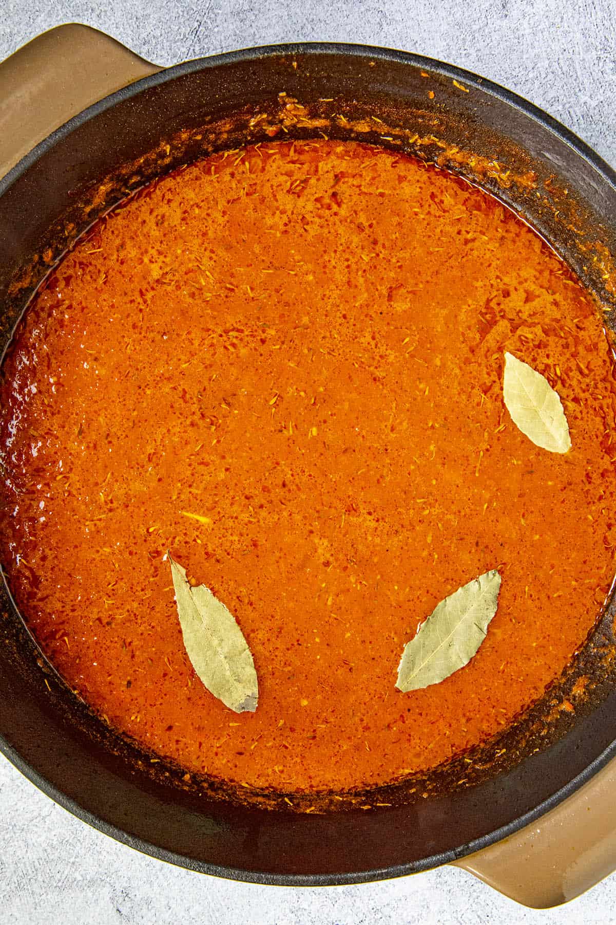 Ready to simmer the seasoned tomato-pepper puree with stock for making Jollof rice