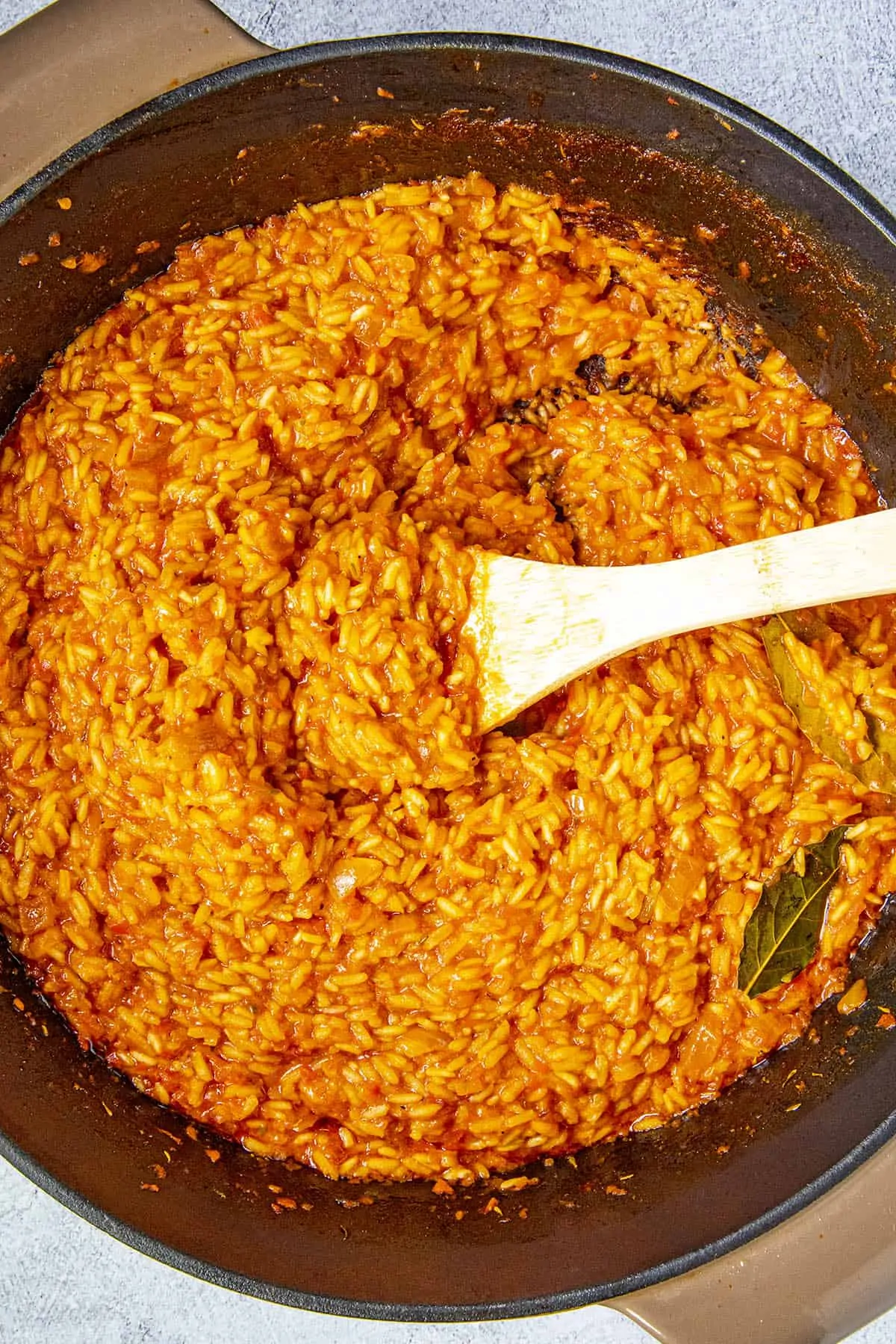 Stirring the jollof rice in the pot