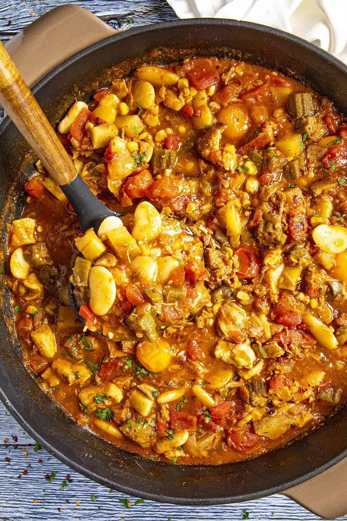 Serving a scoop of Brunswick Stew from the pot.