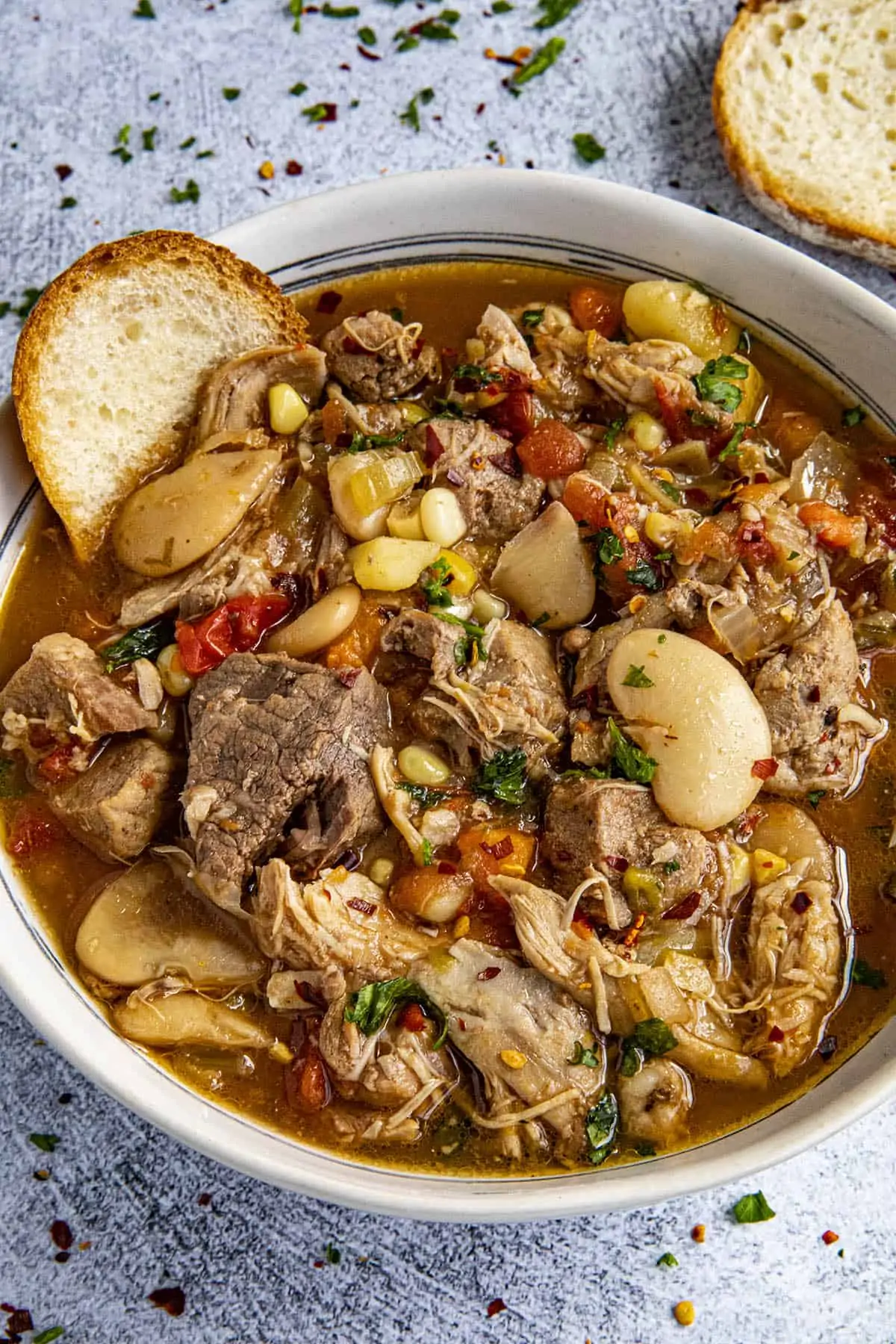 Chunky burgoo stew in a bowl with bread