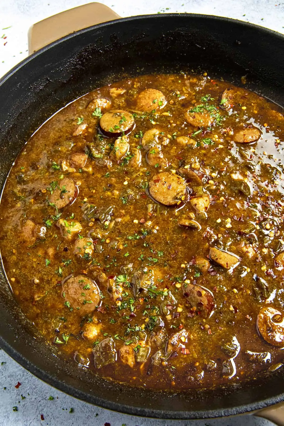 Cajun Chicken and Sausage Gumbo in a pot with garnish