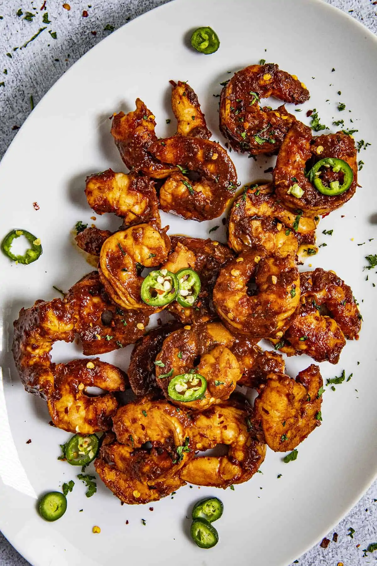 Spicy Camarones a la Diabla on a plate with sliced peppers