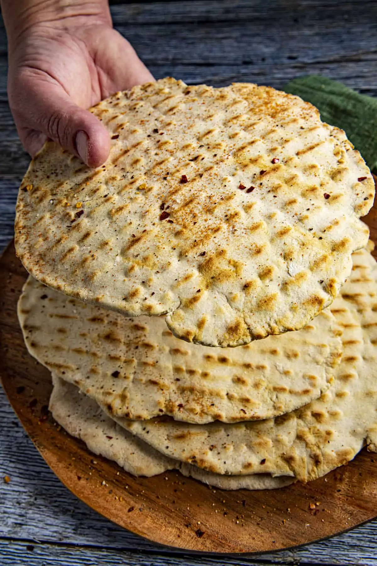 Mike lifting a piece of crackery flatbread from the plate.