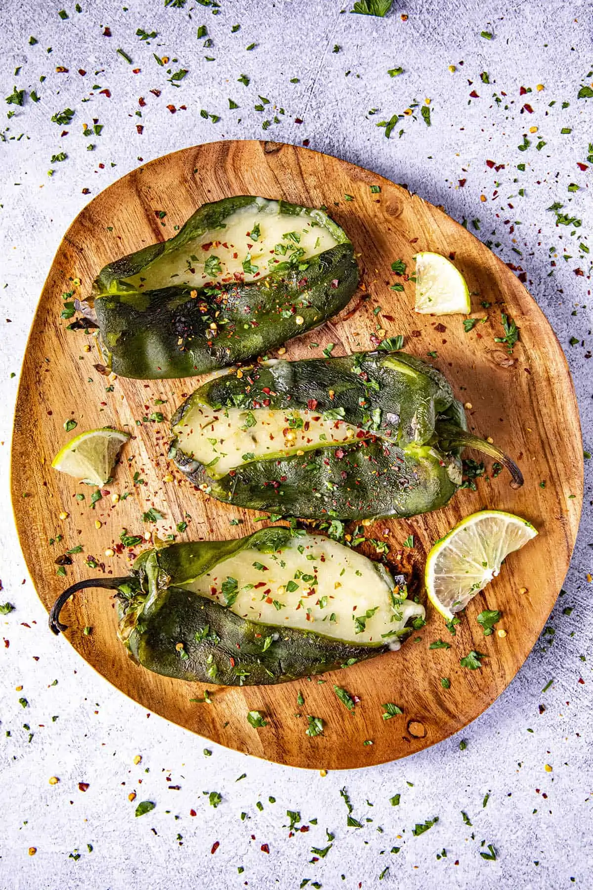Three Grilled, Cheese Stuffed Poblano peppers on a plate