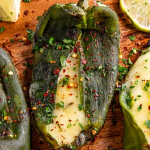 A poblano pepper that has been stuffed with cheese and grilled