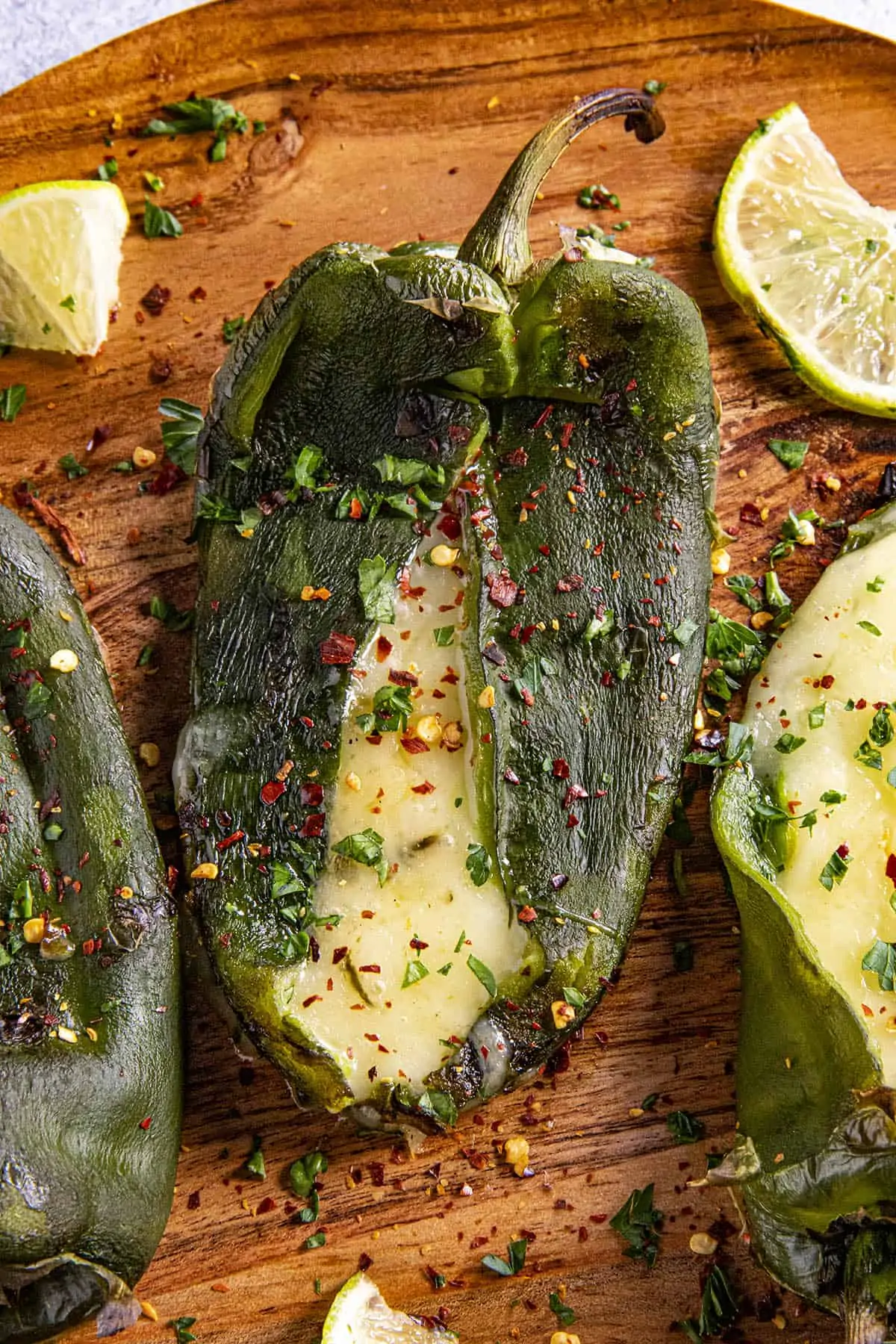 A poblano pepper that has been stuffed with cheese and grilled