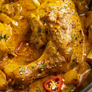 Mike scooping a piece of Jamaican Curry Chicken to serve