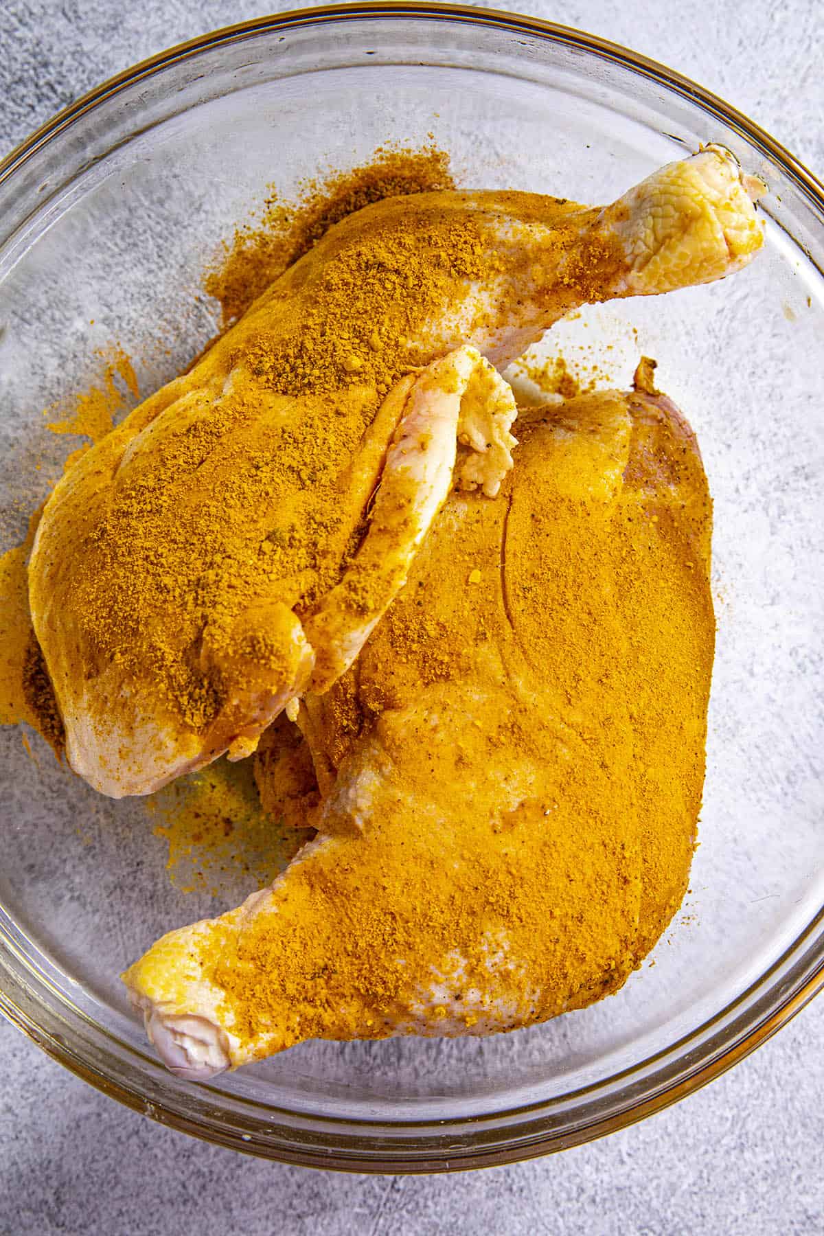 Seasoning 2 large pieces of chicken with homemade Jamaican Curry powder