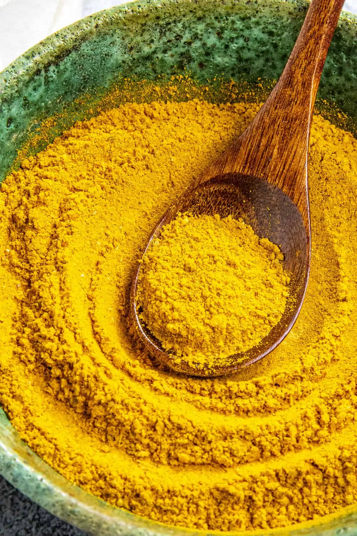 Mike scooping Jamaican Curry Powder onto a serving spoon.