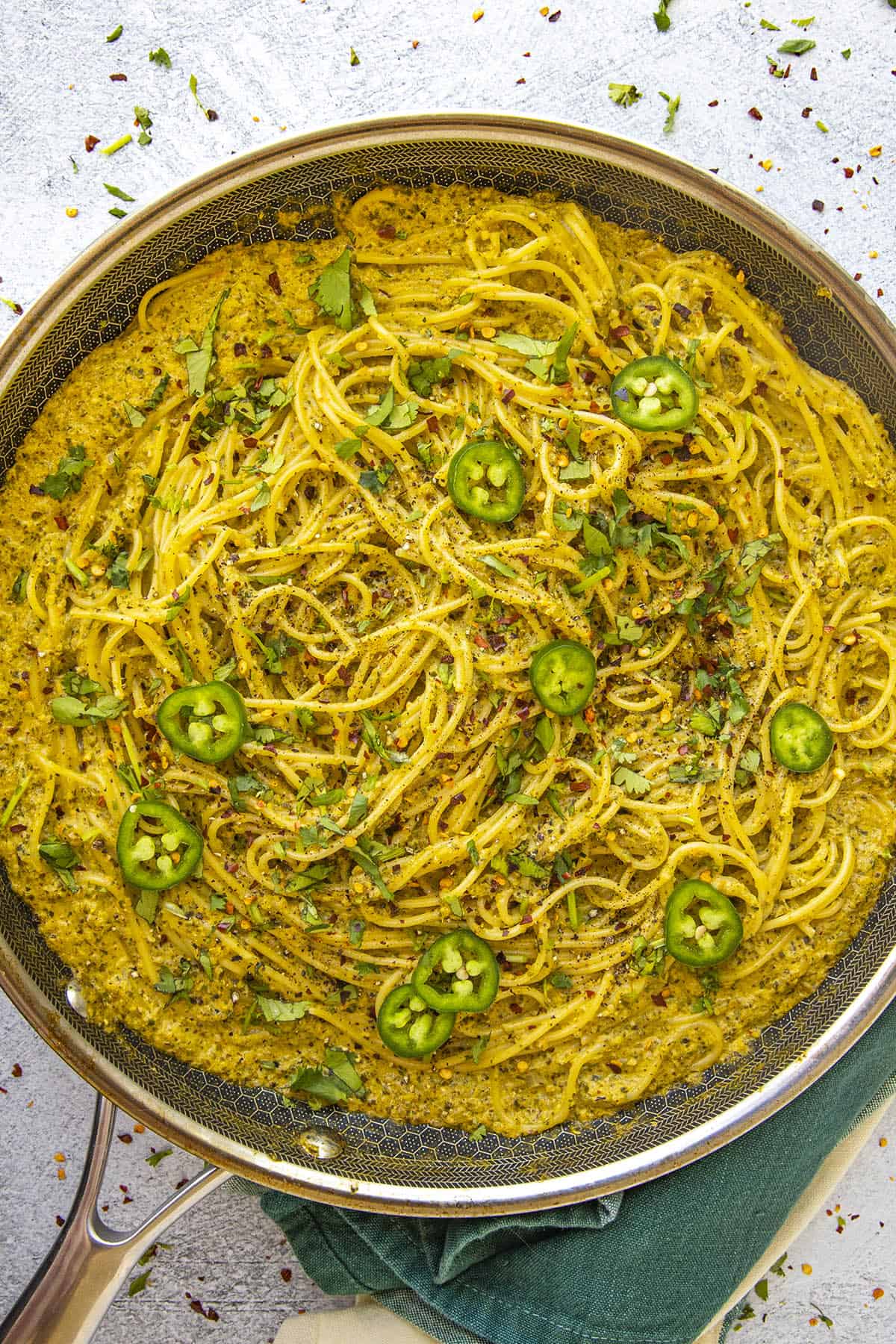 Green spaghetti in a pan, ready to serve