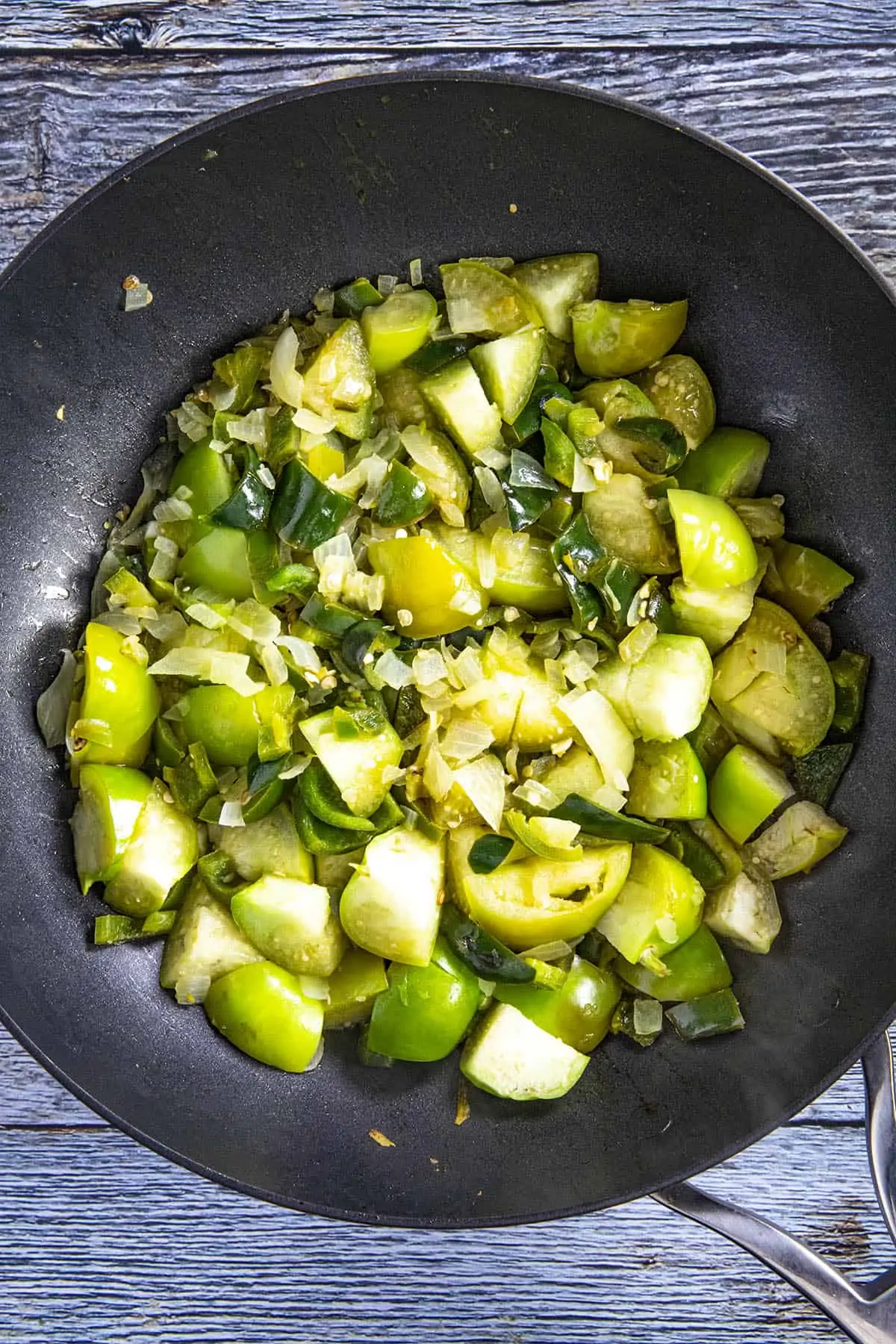 Cooking down the tomatillos and onions to make Spaghetti Verde