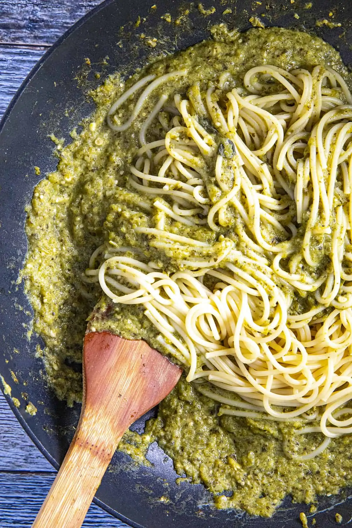 Swirling cooked spaghetti noodles into the Spaghetti Verde sauce