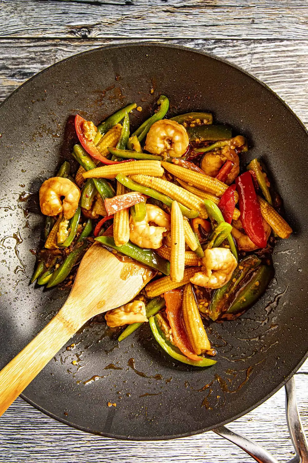 Stirring together the Teriyaki Shrimp Stir Fry ingredients in a pan