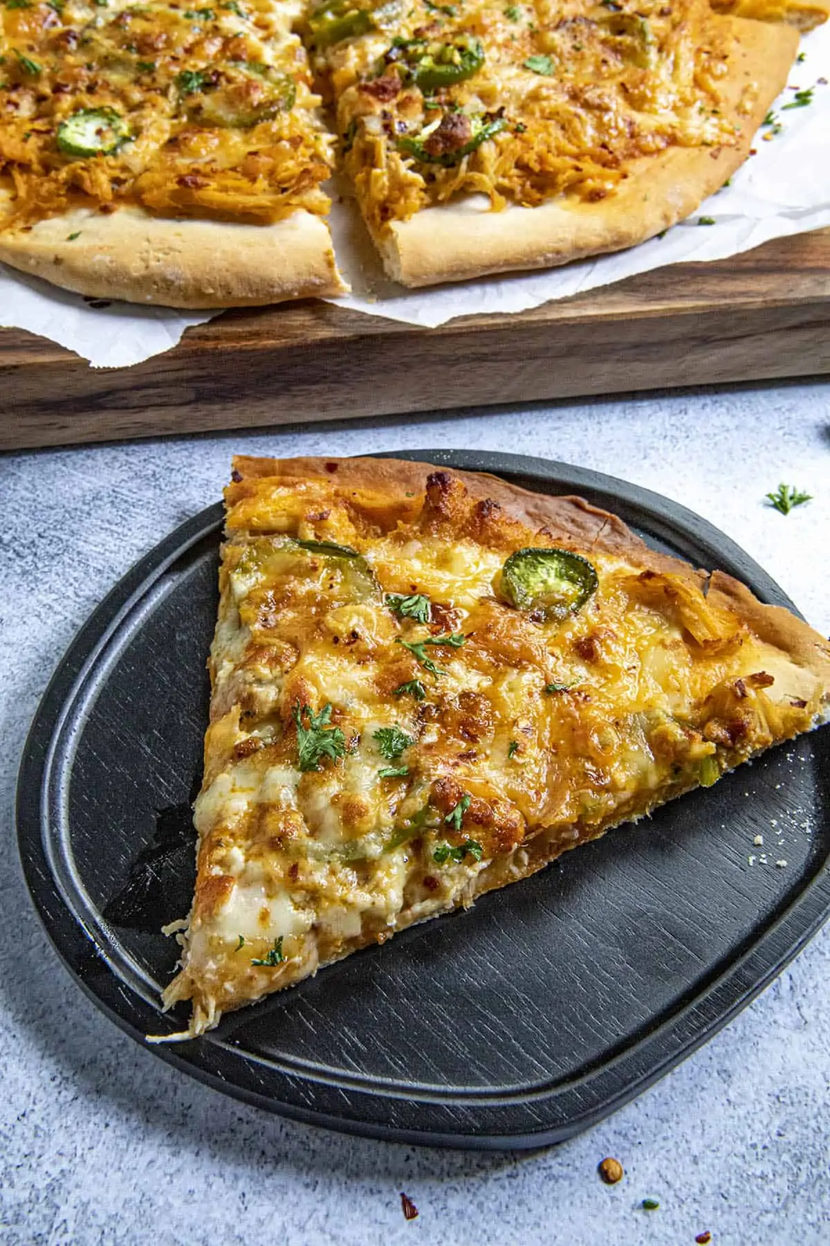 A slice of Buffalo Chicken Pizza on a plate, ready to eat