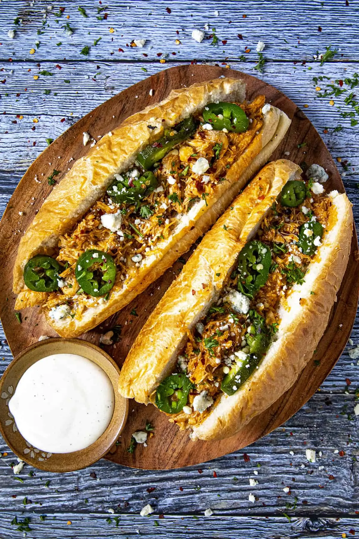 Buffalo chicken sandwiches on a serving platter with dressing on the side