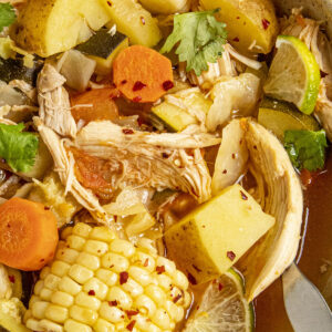 Chunky Caldo de Pollo in a bowl with lots of chicken and vegetables