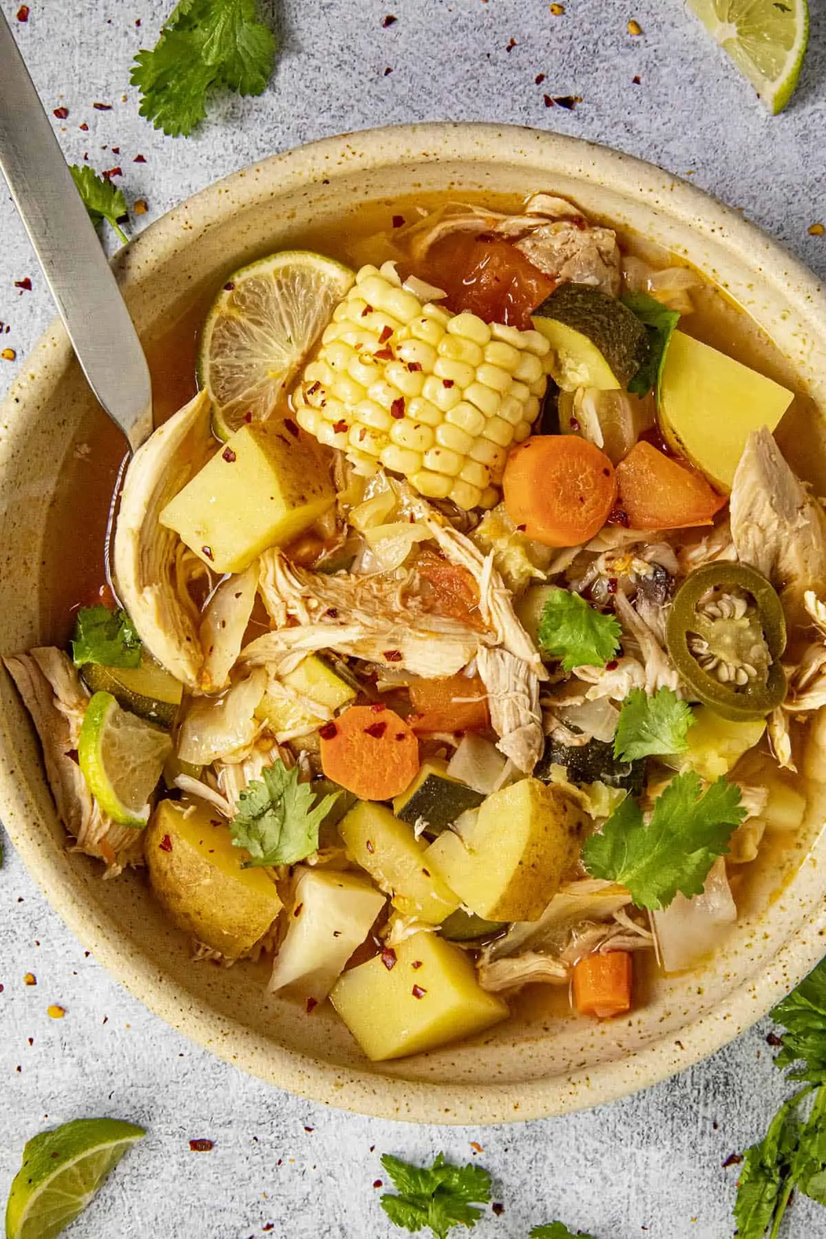 Mike taking a scoop of chunky Caldo de Pollo from a bowl