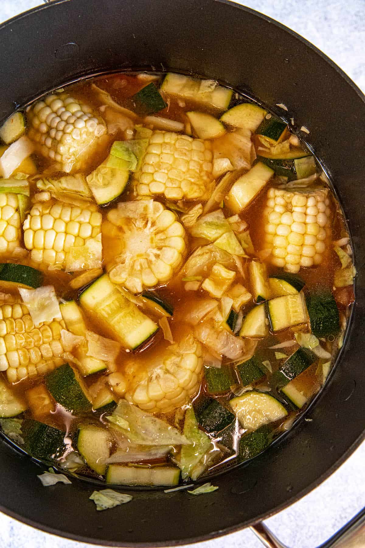 Simmering Caldo de Pollo in a pot