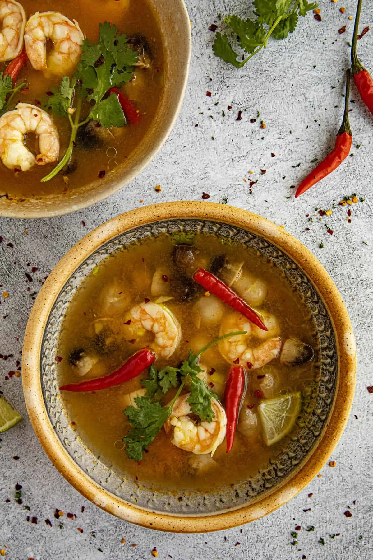 Tom Yum Soup in a bowl with lots of peppers