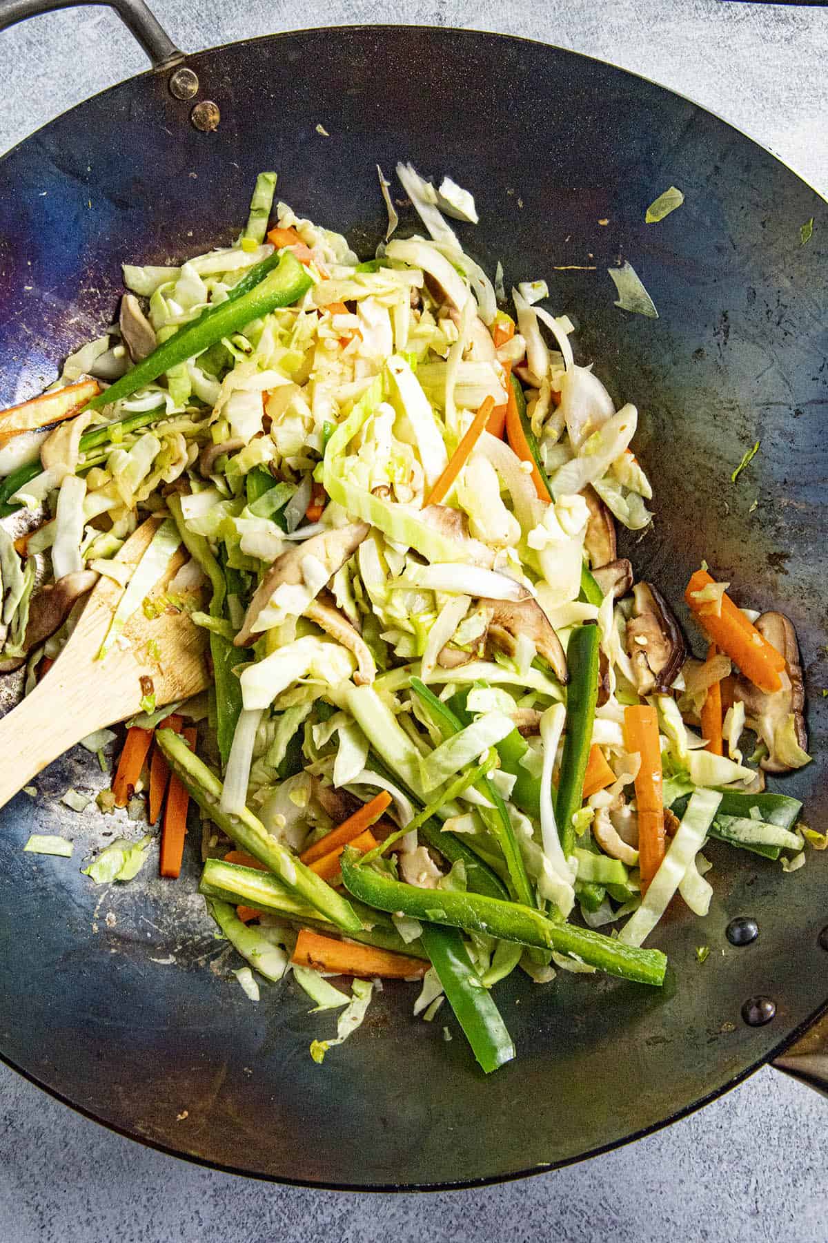 Stir frying the vegetables in the hot wok