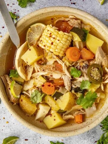 Mike taking a scoop of chunky Caldo de Pollo from a bowl