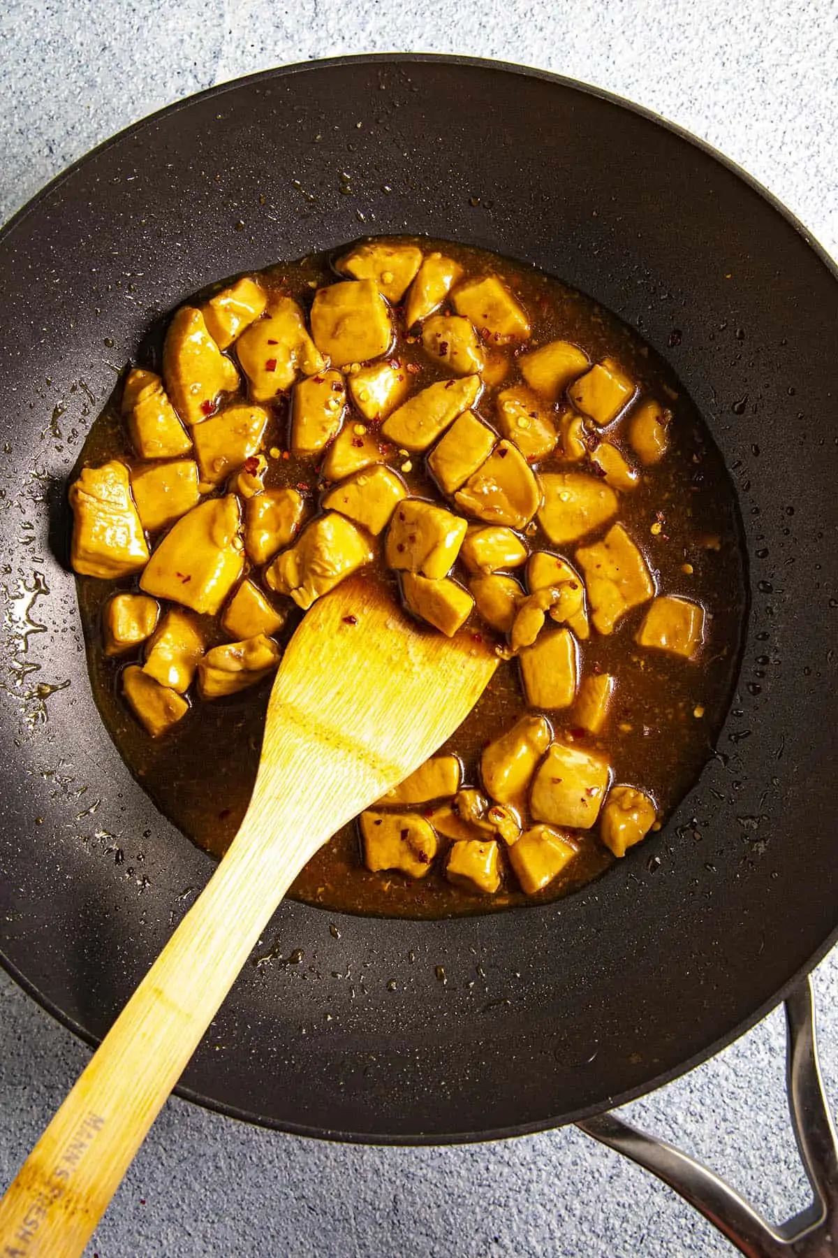 Thickening the Bourbon Chicken sauce in the wok