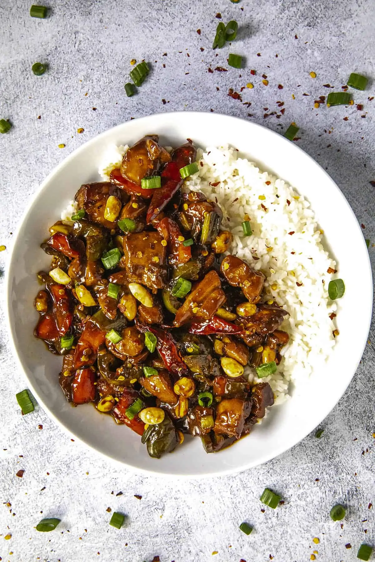 Kung Pao Chicken in a bowl with rice and peanuts