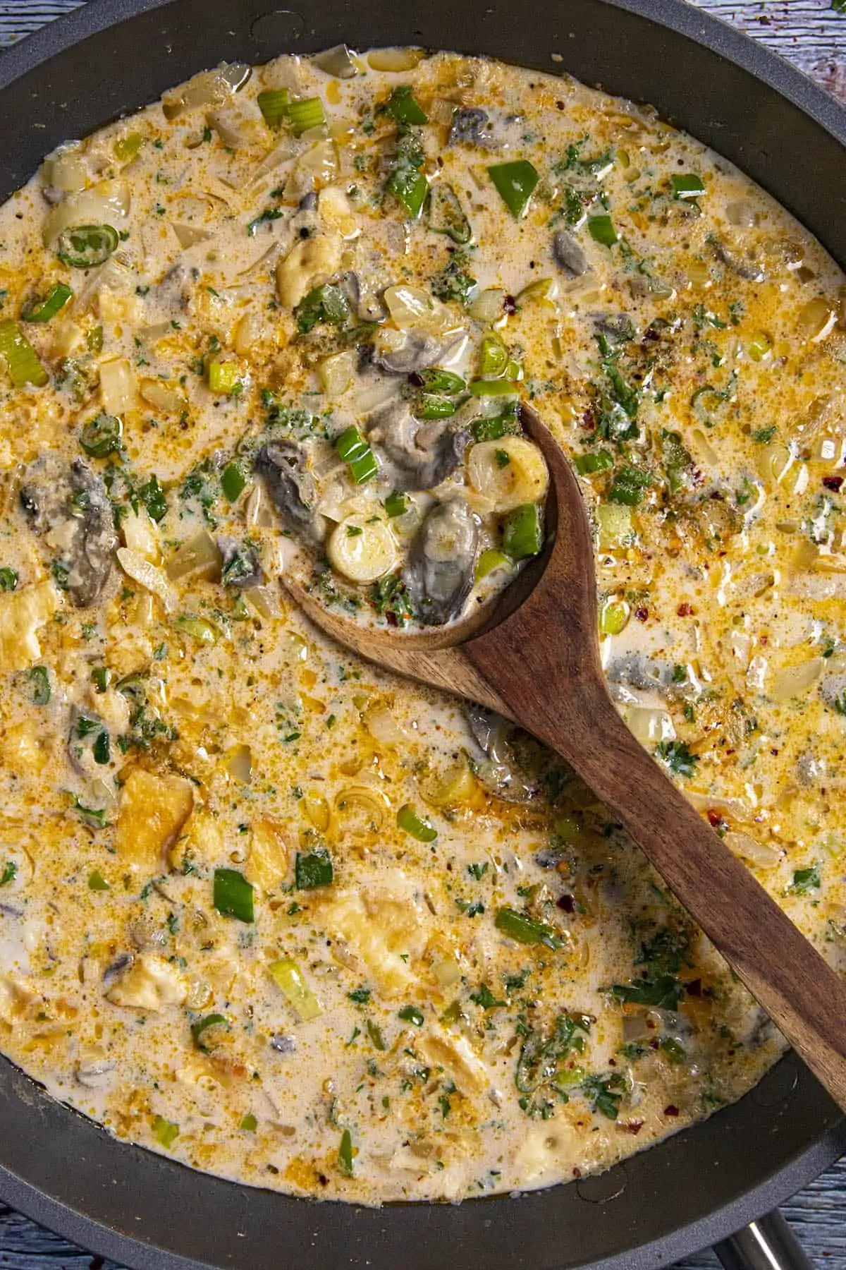 Scooping up a spoonful of Oyster Stew from the pan