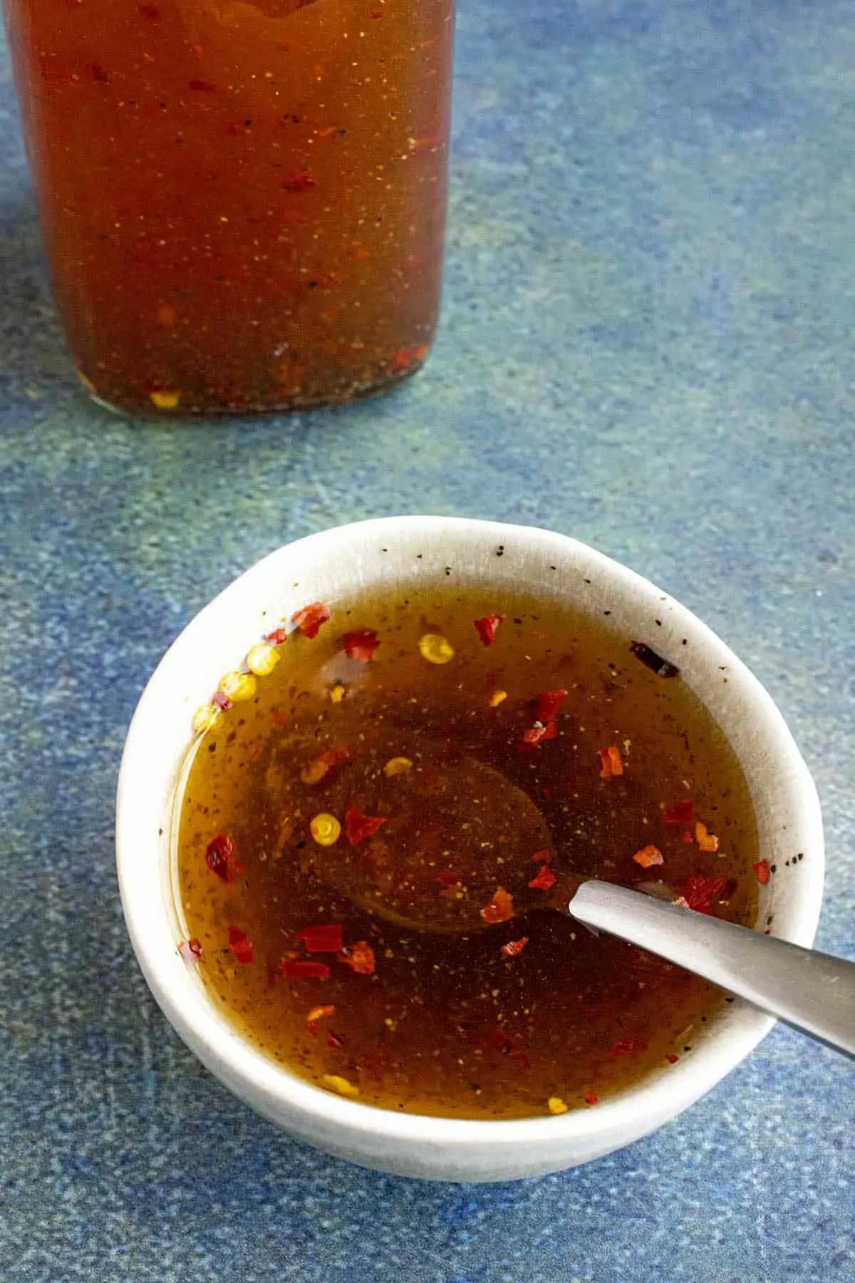 Carolina Vinegar BBQ Sauce in a bowl with a spoon.